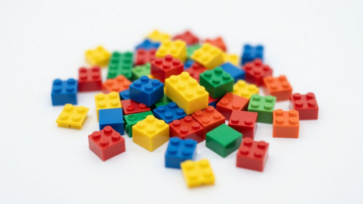 Colorful magnetic building blocks scattered on a surface.