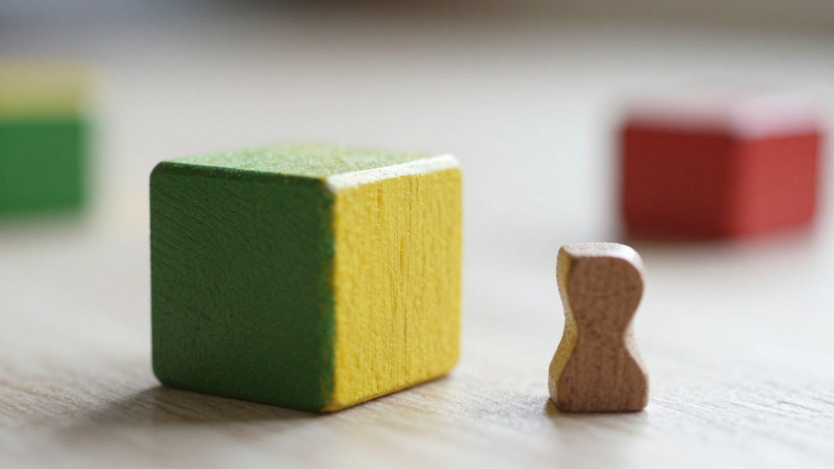 Wooden toy block with a small detached piece.