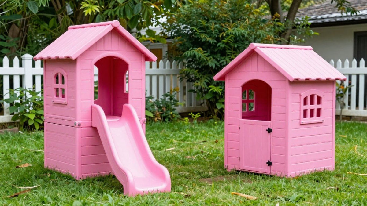Pink playhouses in a sunny backyard with green grass.