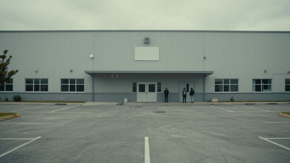 Pride Manufacturing factory closed, employees looking sad outside.